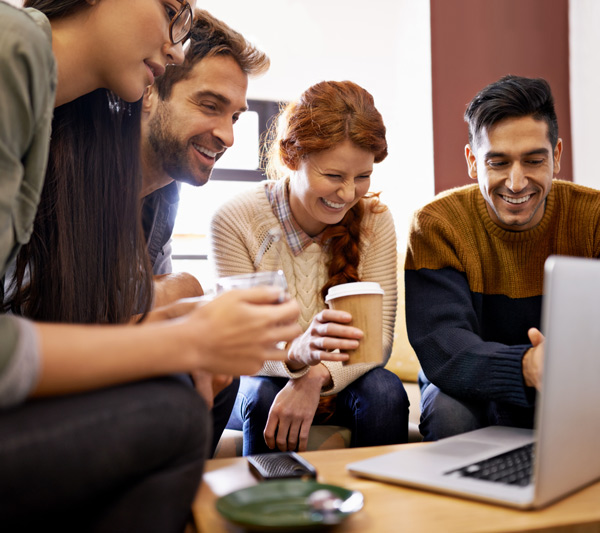 four friends enjoying coffee together while sharing a fun moment looking at a laptop screen in a cozy setting 3 ways to connect